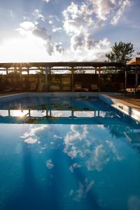 a swimming pool with the sky in the water at Boutique Hotel Casa Art in Oreshak
