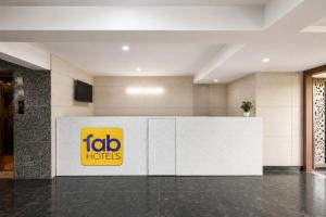 an office lobby with a tubo hotel sign on the wall at FabHotel Snereya in New Delhi