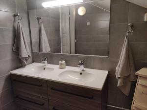 a bathroom with a sink and a mirror at Omenapolun Onni in Taipalsaari +6 photos