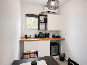 a kitchen with a counter and a table and a sink at Coconut beach villas 1 in Schinias