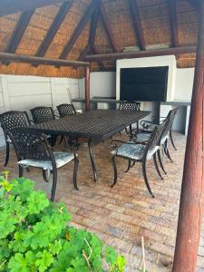 a picnic table and chairs on a patio at House Foxglove in Paarl