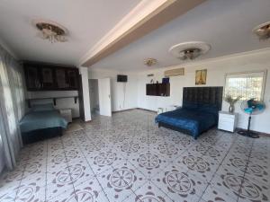 a living room with a blue couch and a floor at Nomty House in Durban