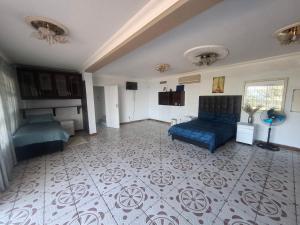 a bedroom with a blue bed and a tile floor at Nomty House in Durban +19 photos