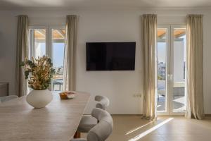 a living room with a table with a vase on it at Estia Villas Naxos in Naxos Chora