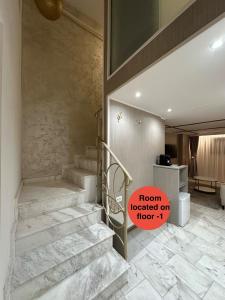 a room with stairs and a sign that says iron located on floor at House4You - Blanari in Bucharest