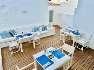 a room with tables and chairs and a couch at Hotel Ca S'Arader Turismo de Interior in Ciutadella