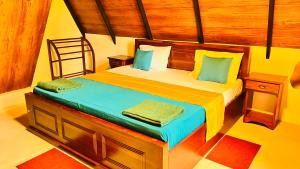 a bedroom with a bed with a wooden headboard at Yashi's Place Sigiriya in Sigiriya