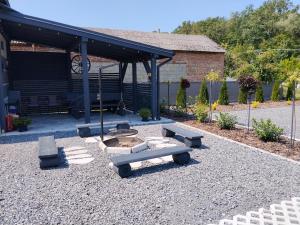 a picnic area with benches and a pavilion at Domek pod lasem in Karmanowice