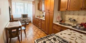 a kitchen with a sink and a stove top oven at Arman in Yerevan