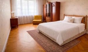 a bedroom with a large white bed and a chair at Arman in Yerevan