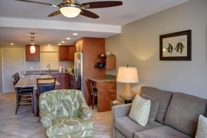 a living room and kitchen with a couch and a table at Pacific Shores B303 in Kihei