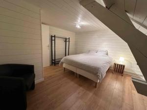 a bedroom with a bed in a room with an attic at Authentic rural square farm in Poperinge +20 photos