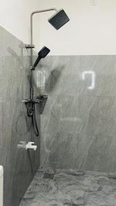 a shower with a shower head in a bathroom at Yashi's Place Sigiriya in Sigiriya +291 photos