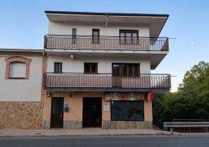 a building with a balcony on top of it at La Casa De Marta in Piedralaves