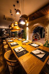 a large wooden table in a restaurant with chairs at Viva Suites Cappadocia in Nevşehir