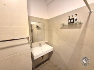a bathroom with a sink and a mirror at Eagles Hideout Kandy in Bowala +62 photos