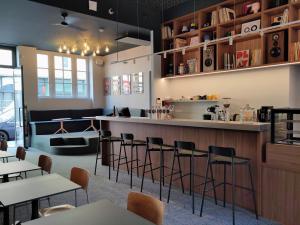 a bar in a restaurant with tables and chairs at SLO Hostel Lyon Saxe in Lyon