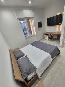 a bedroom with a large bed and a desk at Mirabaia in Bacoli