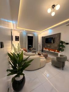 a large living room with a couch and a table at Abban homes in Kampala