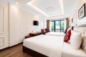 a hotel room with a bed and a television at Golden Sail Hotel & Travel in Hanoi