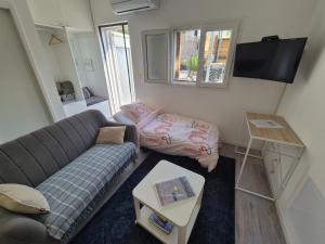 a living room with a couch and a table at Rhône Studio avec terrace parking privé in Viviers