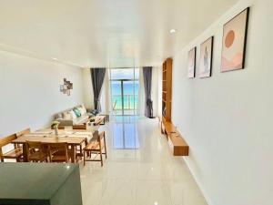 a dining room and living room with a table at Ocean Vista 3BR apt Sealinks Resort, Mui Ne, Phan Thiet in Phan Thiet