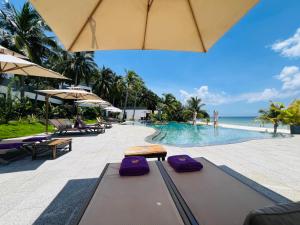 a pool at a resort with purple yoga mats at Apsara Resort Koh Rong in Koh Rong Island