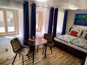 a bedroom with a bed and a table and chairs at Apartmán Kácov in Kácov