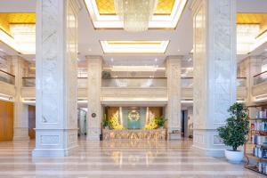 a lobby of a hotel with columns and a library at Honder International Hotel in Guangzhou +111 photos