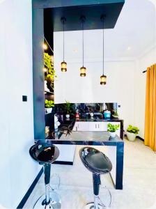 a kitchen with two stools in front of a counter at Villa Lithu in Weligama