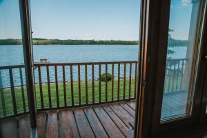 a view of the water from a house balcony at Herrmanns-hof in Kronowo