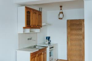 a small kitchen with a sink and a stove at Herrmanns-hof in Kronowo