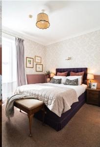 a bedroom with a large bed and a window at Fairlawn House in Amesbury
