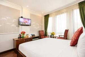 a hotel room with a bed and a flat screen tv at Golden Sail Hotel & Travel in Hanoi