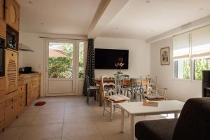 a living room with a table and a dining room at Hôtel & Spa de la Citadelle, Port-Louis - Lorient in Port-Louis