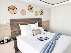 a bedroom with a white bed with a wooden headboard at Cleopatra Palace in Vereeniging