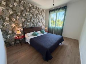 a bedroom with a bed and a wall with flowers at Bed And Breakfast Castello7 in San Felice del Benaco +33 photos