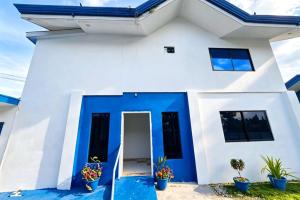 a white and blue house with a blue door at B'lu Bamboo in Moalboal +34 photos