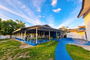 a house with a blue pathway in front of a building at B'lu Bamboo in Moalboal