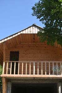 a wooden deck on top of a house at Keria in Ambrolauri
