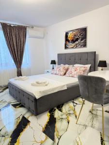a bedroom with a bed and a table and a chair at Vila Dari in Tulcea