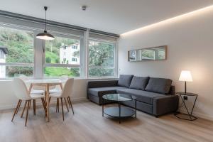 a living room with a couch and a table at Hotel Distrito Oeste by Limehome in San Sebastián