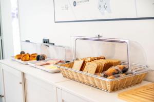 a counter with a basket of bread and other foods at Hotel Distrito Oeste by Limehome in San Sebastián