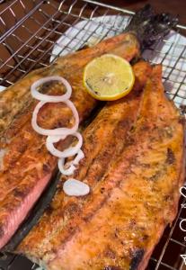 a rack with two pieces of fish and a lemon at ЭКО БАЛЫК Седеп Юурты 
