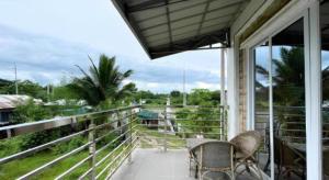 a porch with two chairs and a view of a field at Pilot Hotel in Amandiego