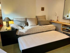 a large bed sitting in a room with a table at Casa Libao-VILLA ENTRE BILBAO Y URDAIBAI CON PISCINA PRIVADA in Arrieta +46 photos