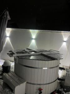 a hot tub with lights on the wall at Casa Roland in Sovata +10 photos