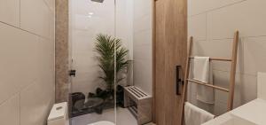 a bathroom with a toilet and a plant in it at The Sultanate Fulhadhoo Baa Atoll in Fulhadhoo