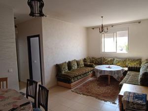 a living room with a couch and a table at Bonnes vacances in Ifrane