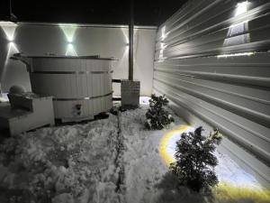 a room with a tub and two christmas trees in the snow at Casa Roland in Sovata